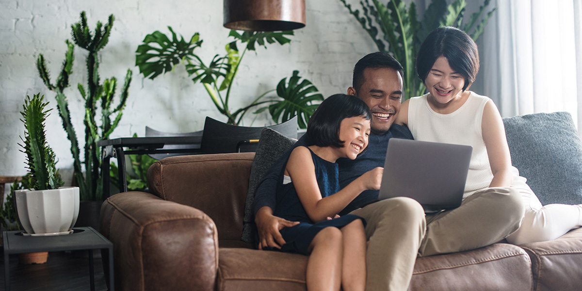 Family looking at laptop